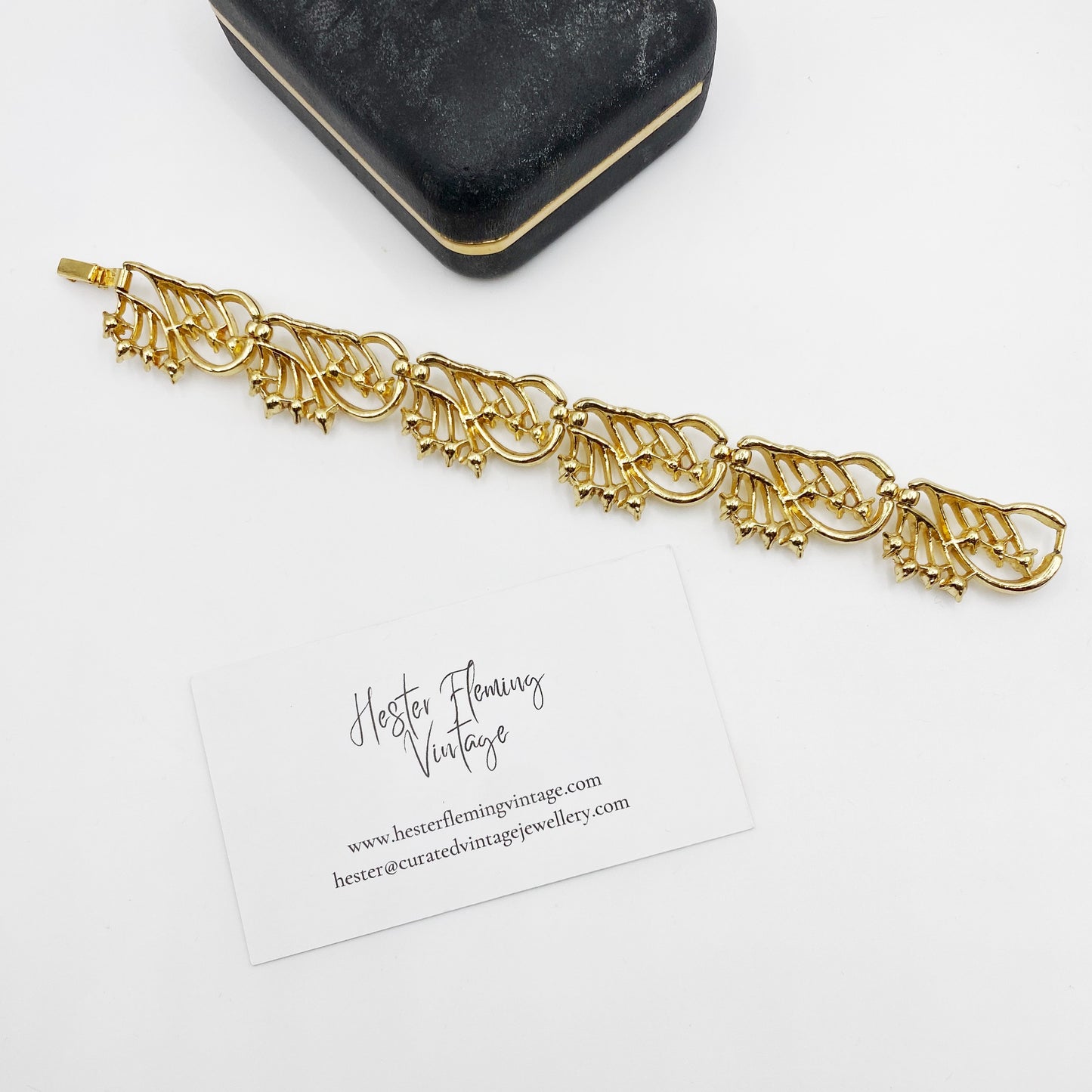 back view of mid-century Crown Trifari gold bracelet with white cabochons.