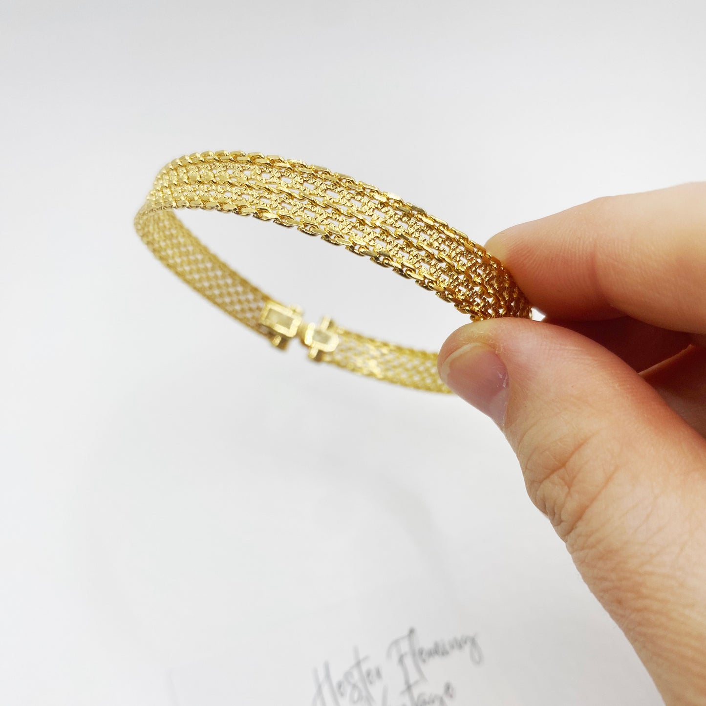 Close-up of the 1970s vintage gold mesh bracelet sourced from London.