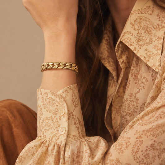 A 1970s Christian Dior Bracelet, styled on a model, wearing retro clothes.