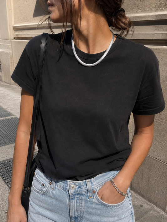 1970s Chain worn by a model in a black tee.