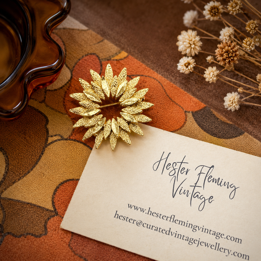 1970s Sunburst Brooch on a retro background.