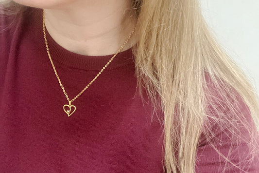 Vintage 1990s heart charm necklace with faux pearl and gold plating.