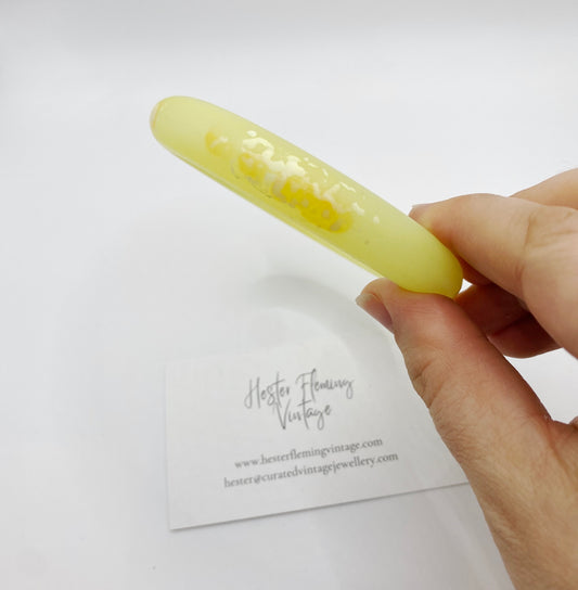 Close up of Vintage Yellow Polymer Bangle, white marbling detail.