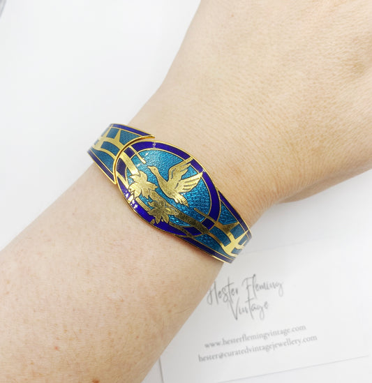 Retro 80s Enamel Cloisonne Bangle, with Swan flying over palm trees. Shown on wrist.