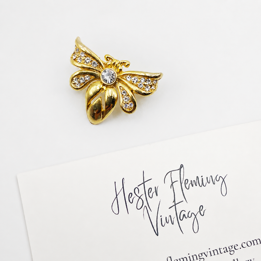 22kt Gold plated, swarovski crystal bee brooch on white background.