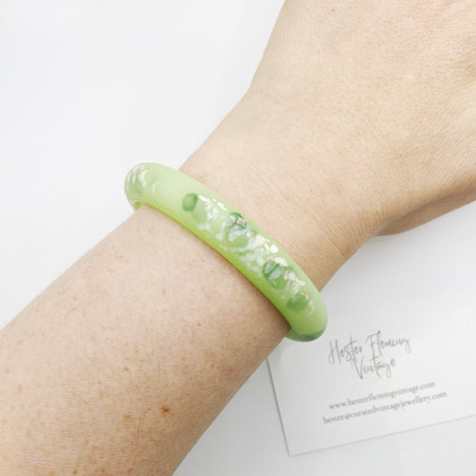 Vintage 80s green polymer bangle on wrist.