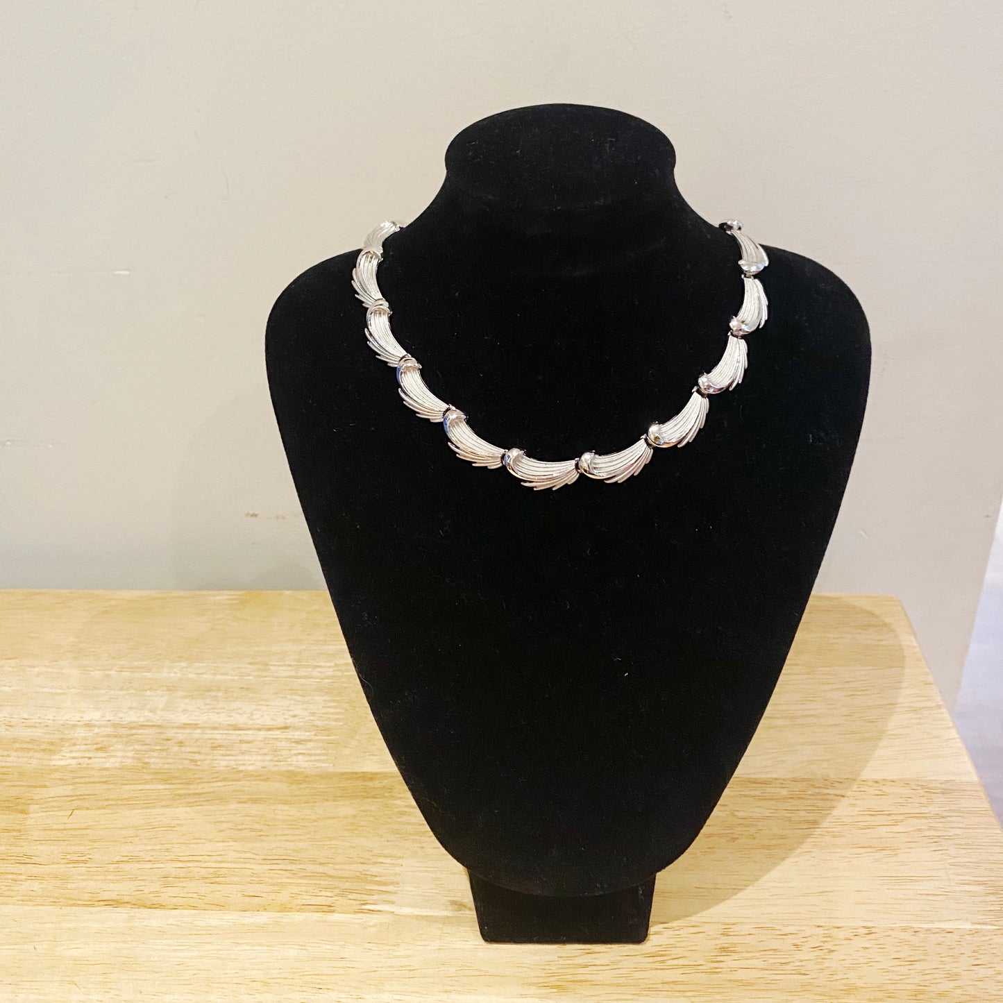 1950s Trifari silver leaf necklace. Collectible vintage jewellery on stand.