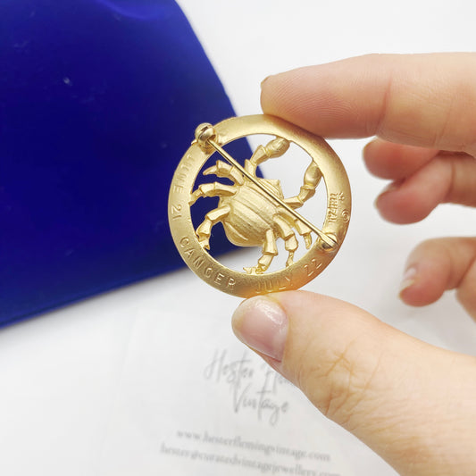 Back of signed Trifari Cancer brooch showing rollover clasp and June 21 – July 22 engraving