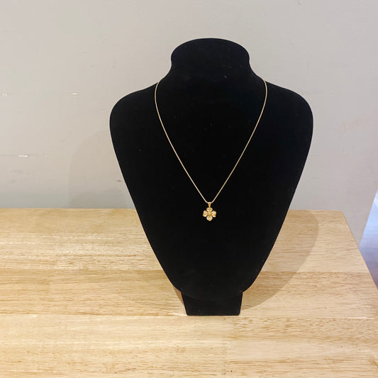 1980s Trifari dogwood pendant worn on black display bust