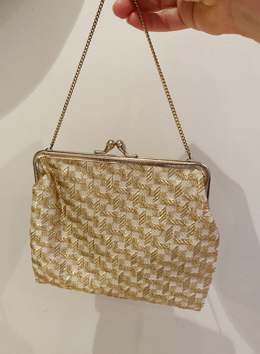 Vintage 1950s–60s gold tinsel weave evening bag with satin lining and brass kiss-lock frame.