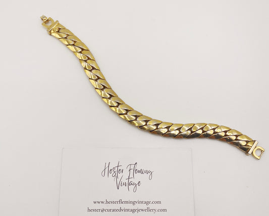 Front view of a vintage 1970s Christian Dior gold link bracelet, signed with CD clasp.
