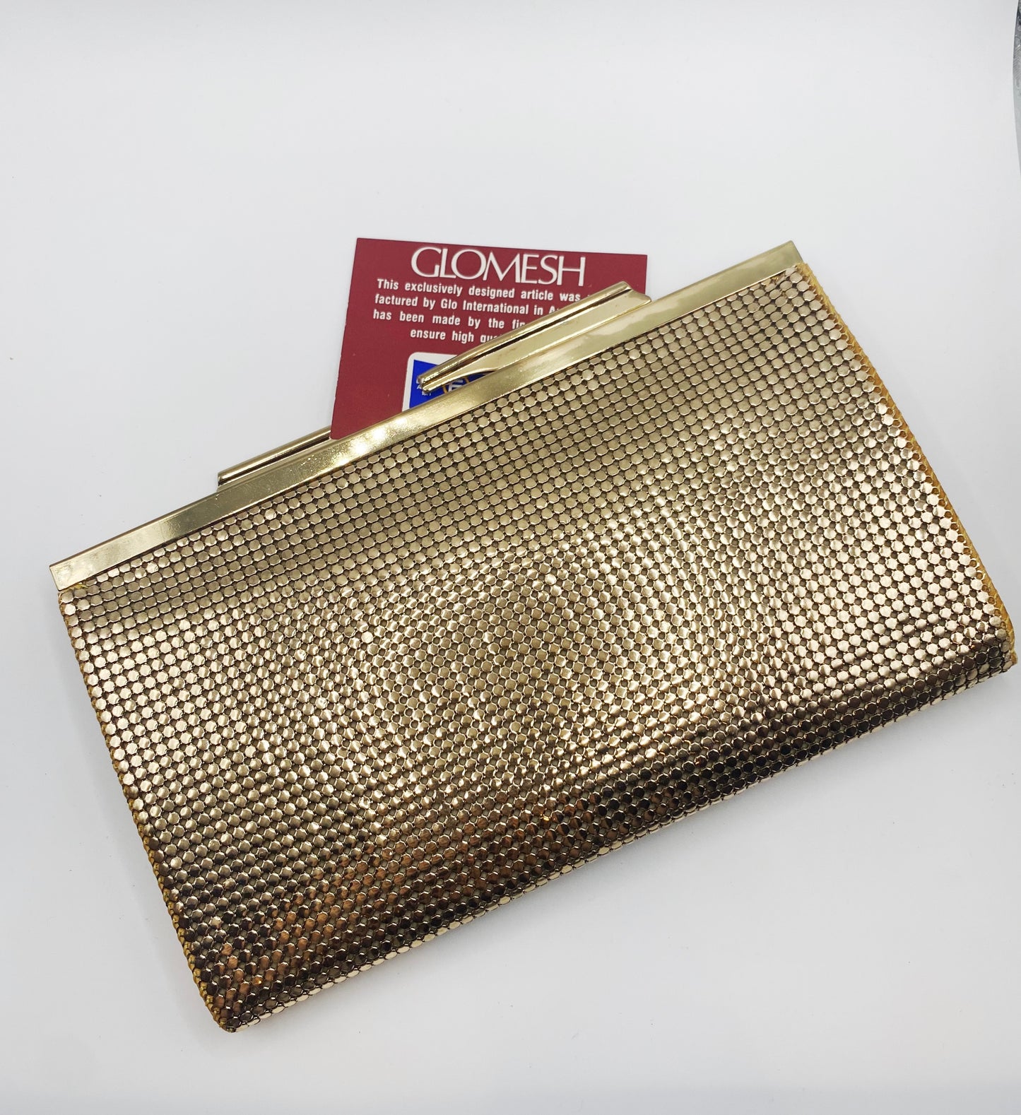 Close-up of gold mesh texture and Glomesh logo, 1977 vintage clutch.