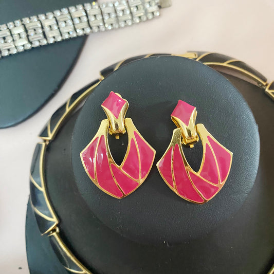 Front view of vintage 1980s magenta enamel clip-on earrings with 22kt gold plating