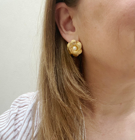 : Vintage 1990s gold and faux pearl earrings for pierced ears on model.