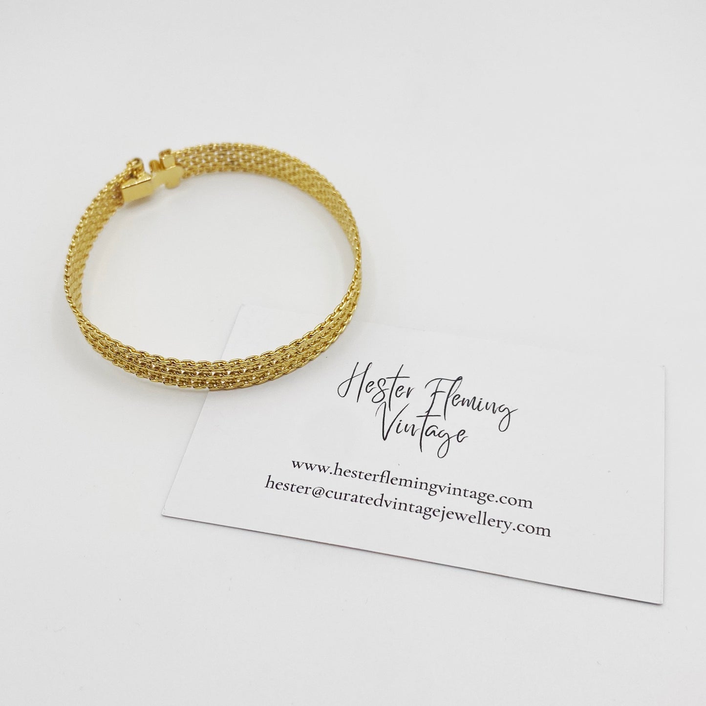 Side view of a vintage 70s gold-plted mesh bracelet.