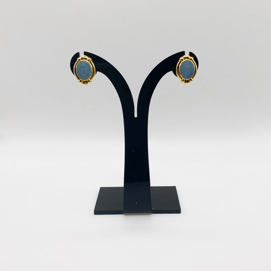 1990s Egyptian Revival Earrings on Black Stand against white background.