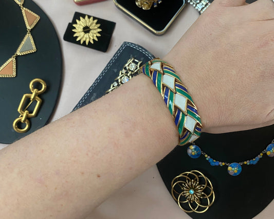 Vintage Crown Trifari bracelet signed 1955 with green, blue, and white enamel.