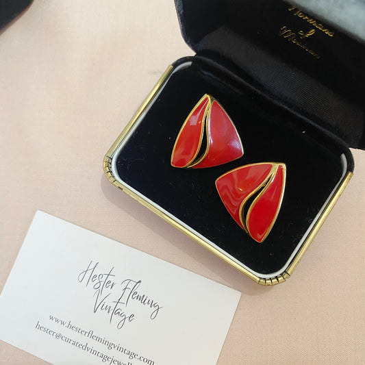 Vintage 1980s Trifari earrings with red enamel in a sail-inspired design.