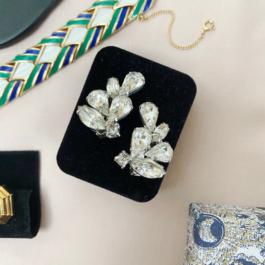 Front view of 1950s vintage Weiss crystal clip-on earrings with navette and round Austrian crystals in silver-tone setting.