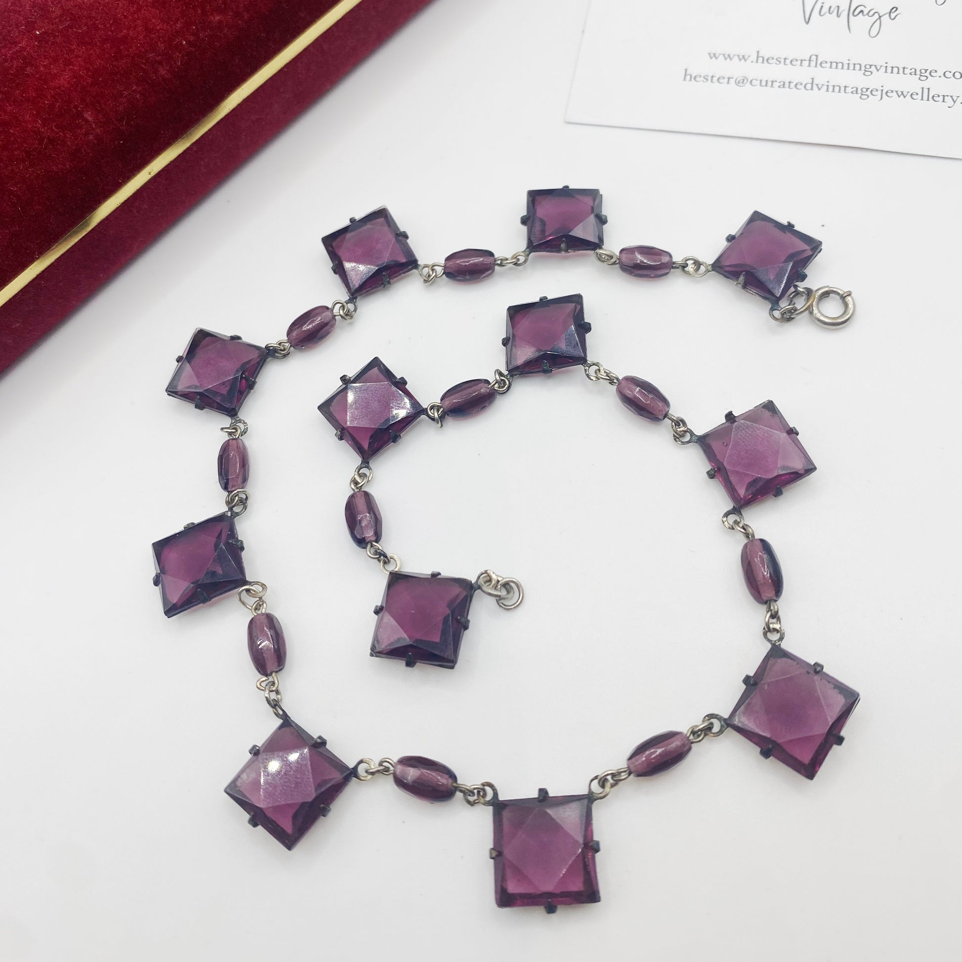 Close up of 1930s Czech amethyst glass crystals in geometric settings