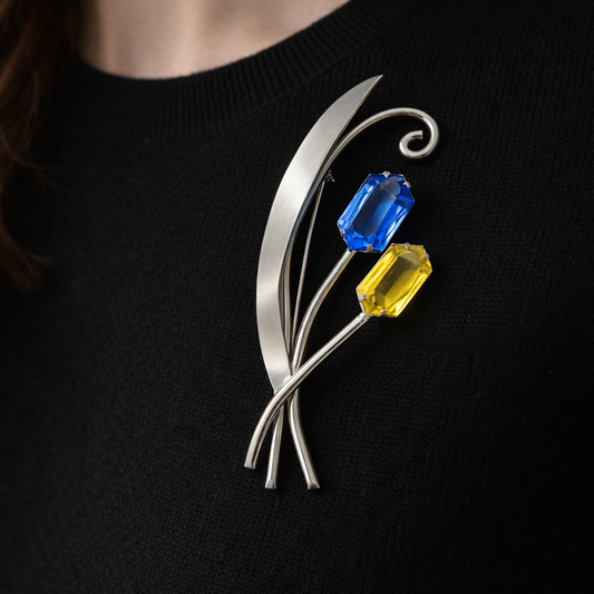 1940s Electric blue and citrine crystal brooch styled on a fine black knit. 