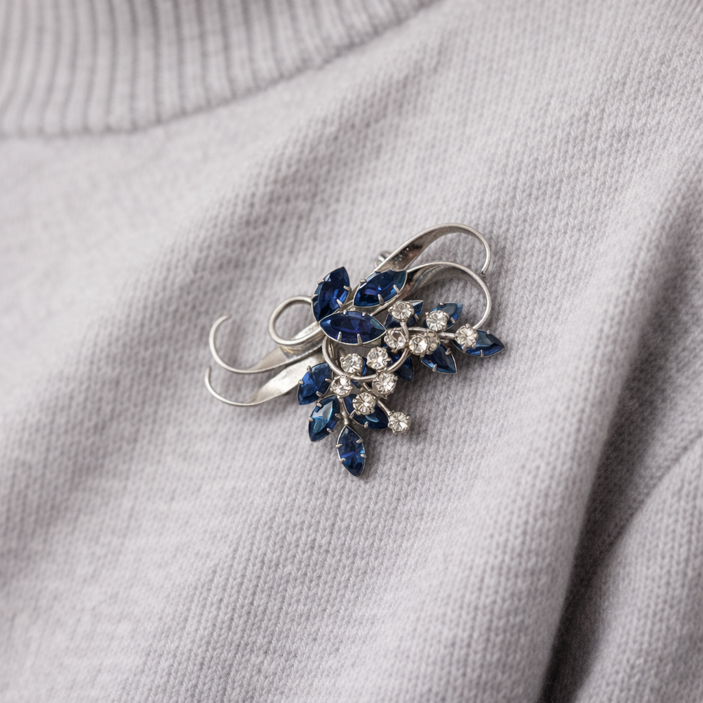 1940s Jewelcrest crystal brooch styled on a grey knit.