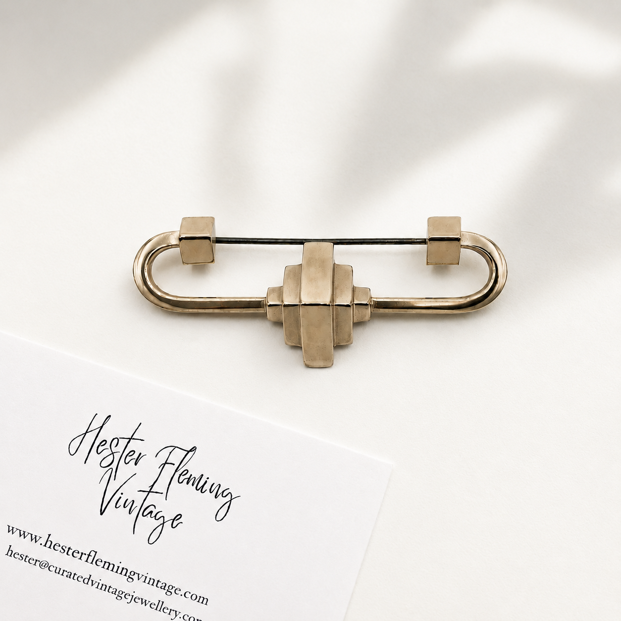Gold safety pin brooch on a white background with 'Hester Fleming Vintage' branding.