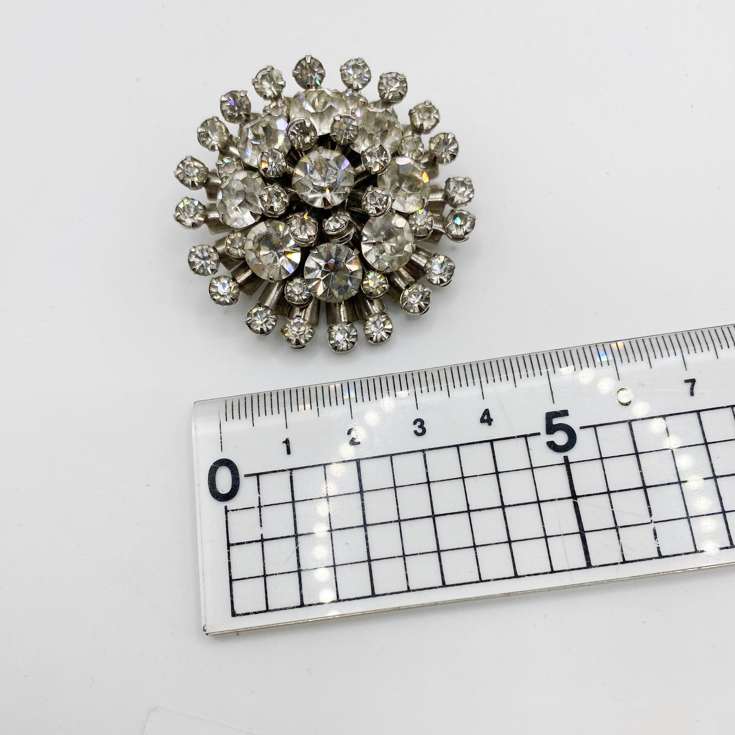 Vintage clear rhinestone burst brooch with layered stones measurement
