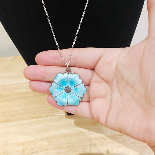 Close-up detail of turquoise vitreous enamel petals and textured silver centre on 1950s Danish pendant