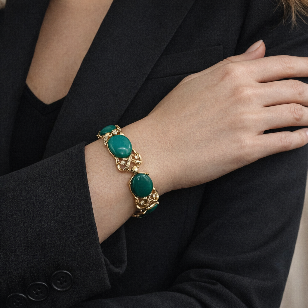 A mid century bracelet by designer, Coro. Styled with a black blazer. 