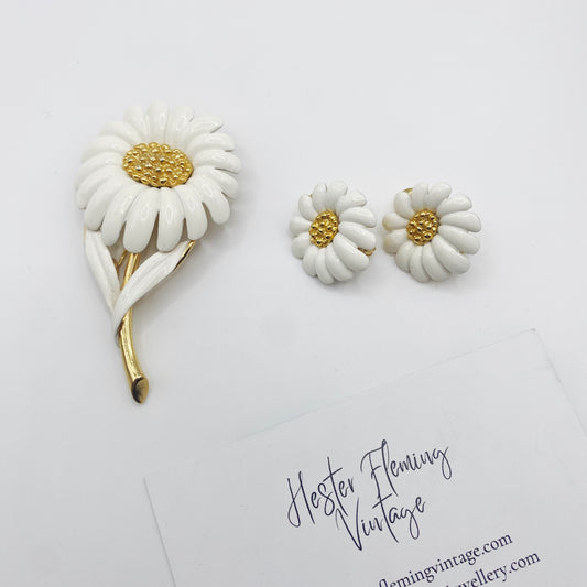 Vintage 1960s Monet enamel daisy brooch and matching clip-on earring set in white enamel and gilt metal.