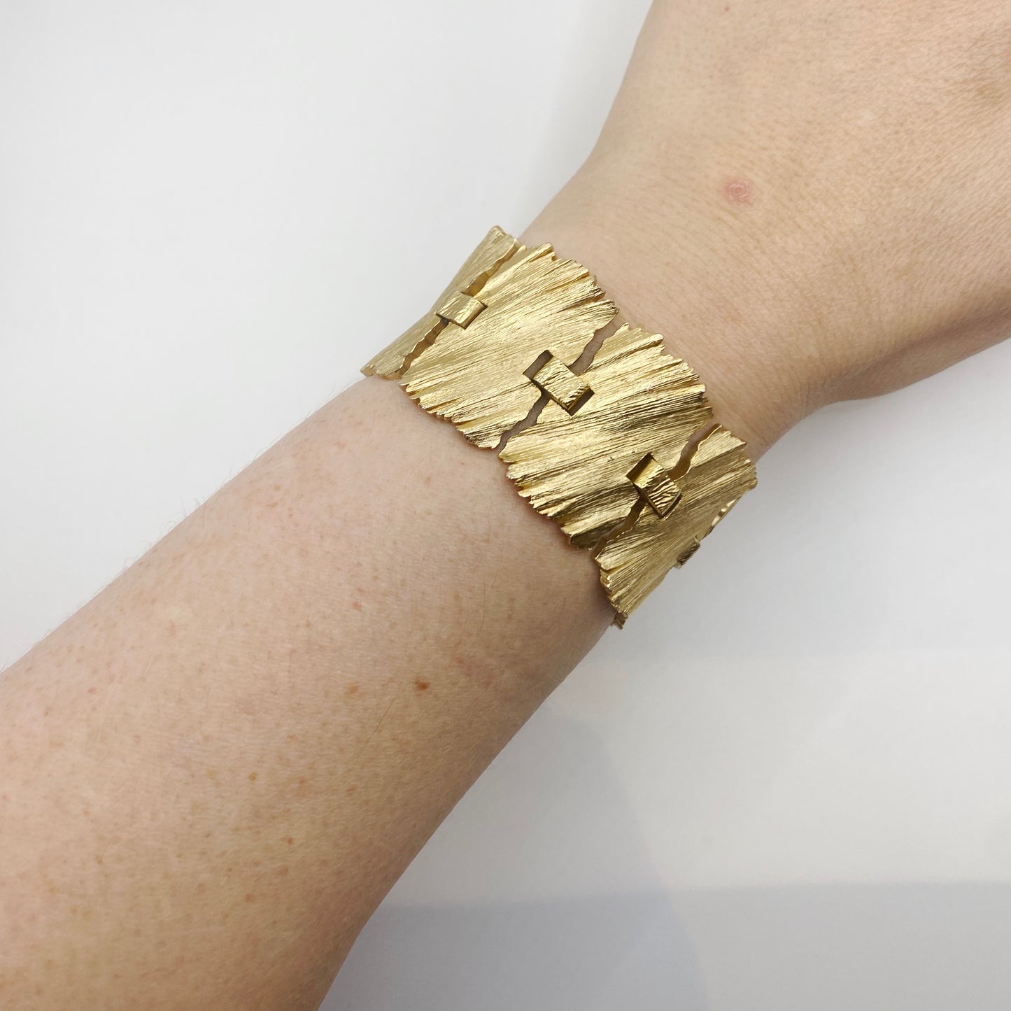 Vintage 1960s Trifari textured gilt metal cuff bracelet.