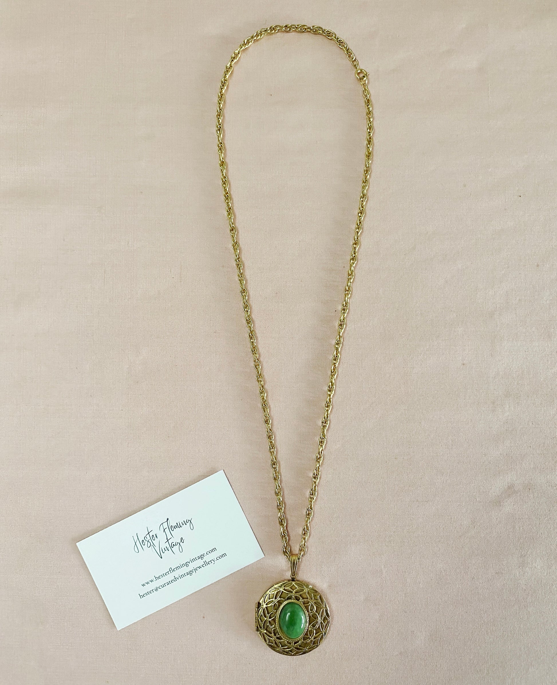 Close-up of jade green vintage locket from the 1960s in gold plating
