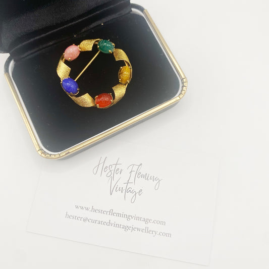 1960s vintage scarab brooch with engraved coloured glass cabochons set in 18kt gold-plated metal, mid-century Egyptian Revival design.