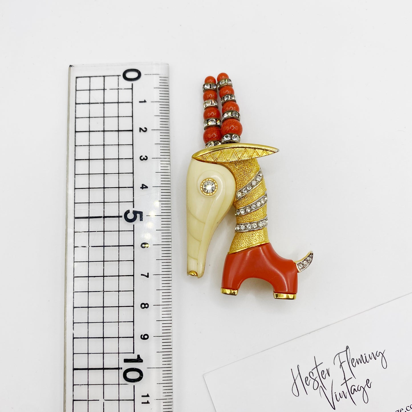 1960s Hattie Carnegie Capricorn Brooch, shown next to a ruler for scale. 