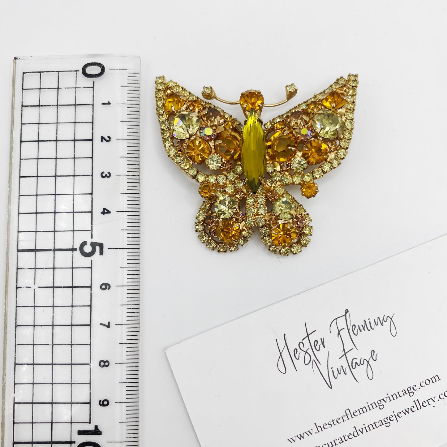 1960s Juliana DE butterfly brooch placed next to ruler for scale. 