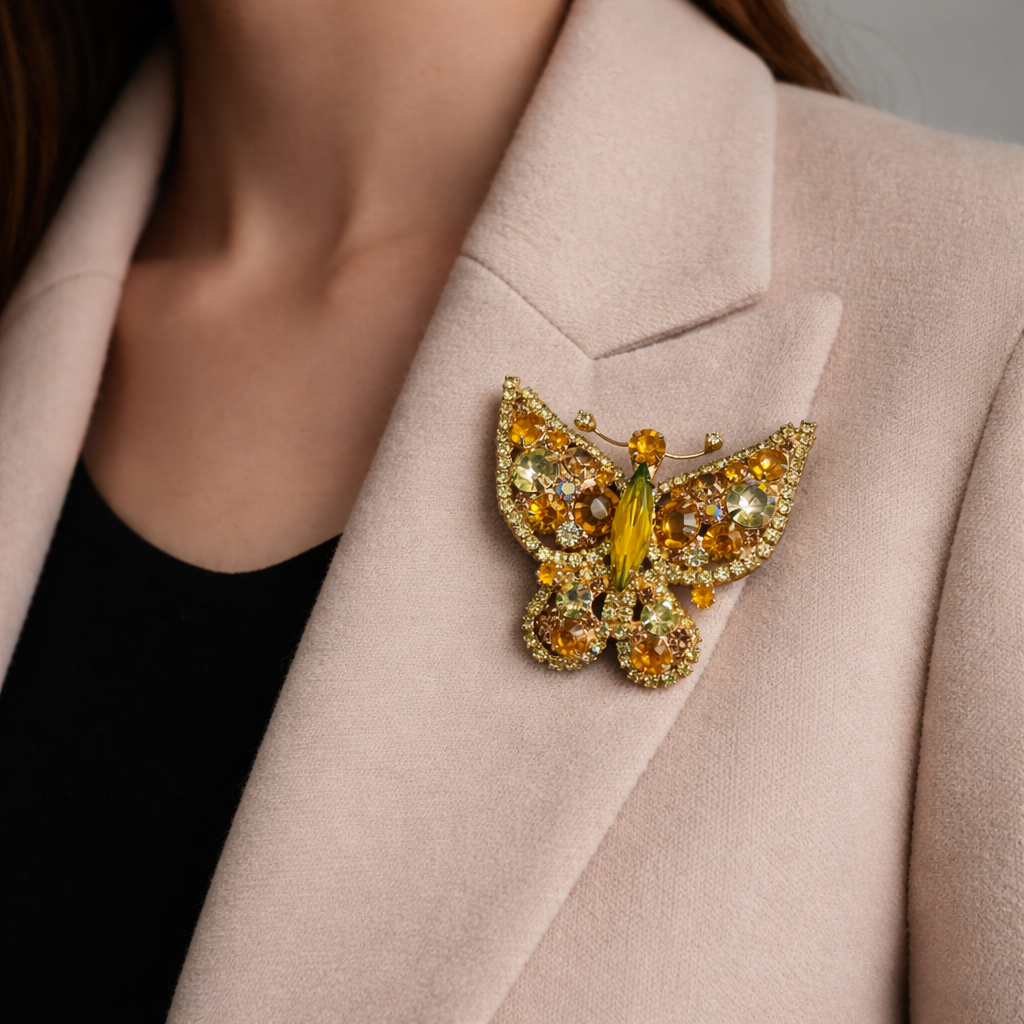 1960s Juliana DE brooch styled on a cream cashmere jacket.