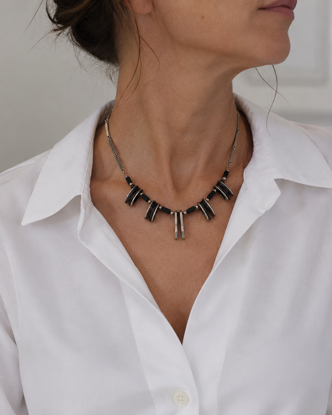 Circa, 1960s MOD Necklace styled on a contemporary model, wearing a white shirt. 