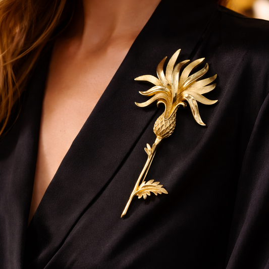 1960s Trifari Gold Tropical Flower Brooch, styled on a silk black dress. 