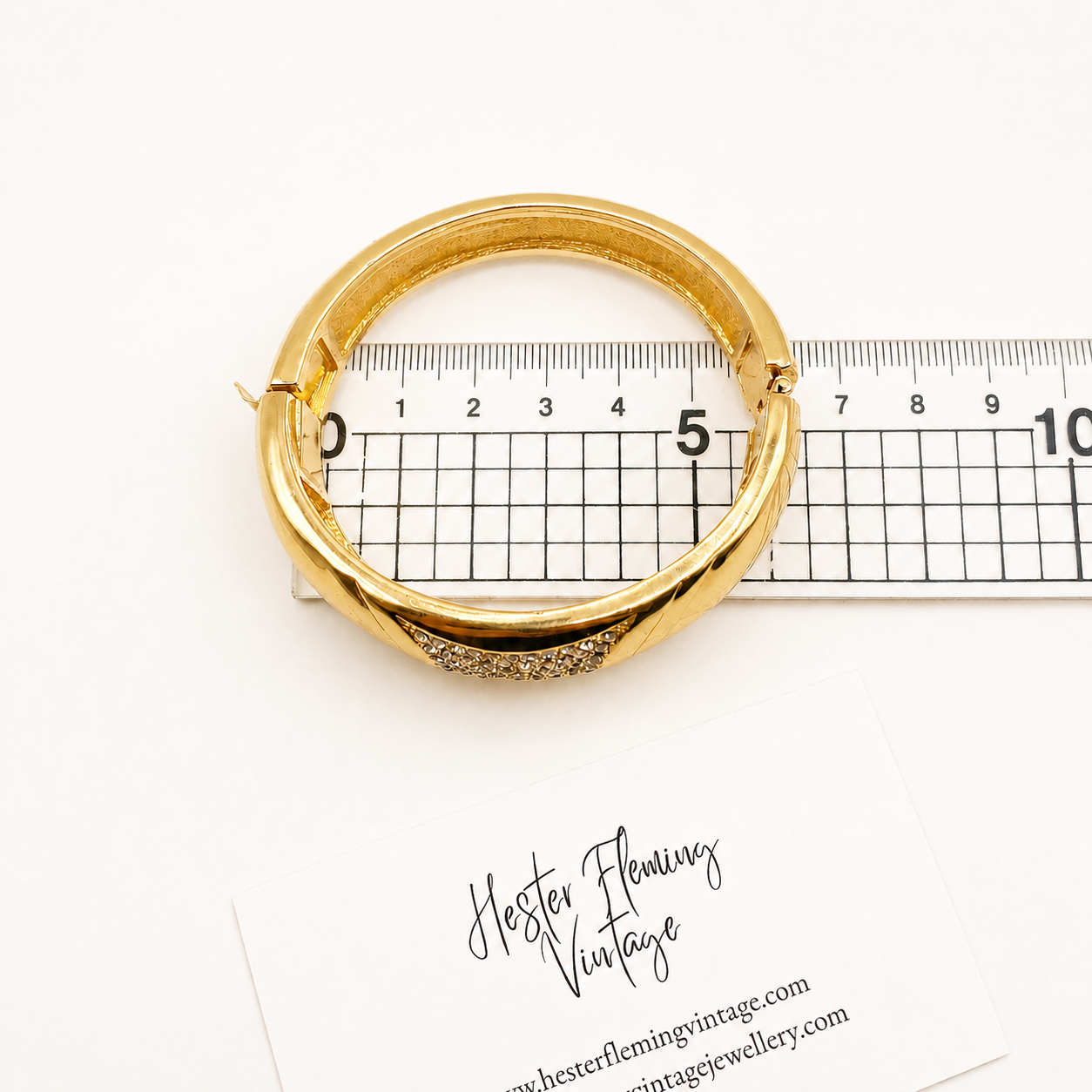 1970s Chr. Dior bangle placed on a ruler for measurement/scale. 