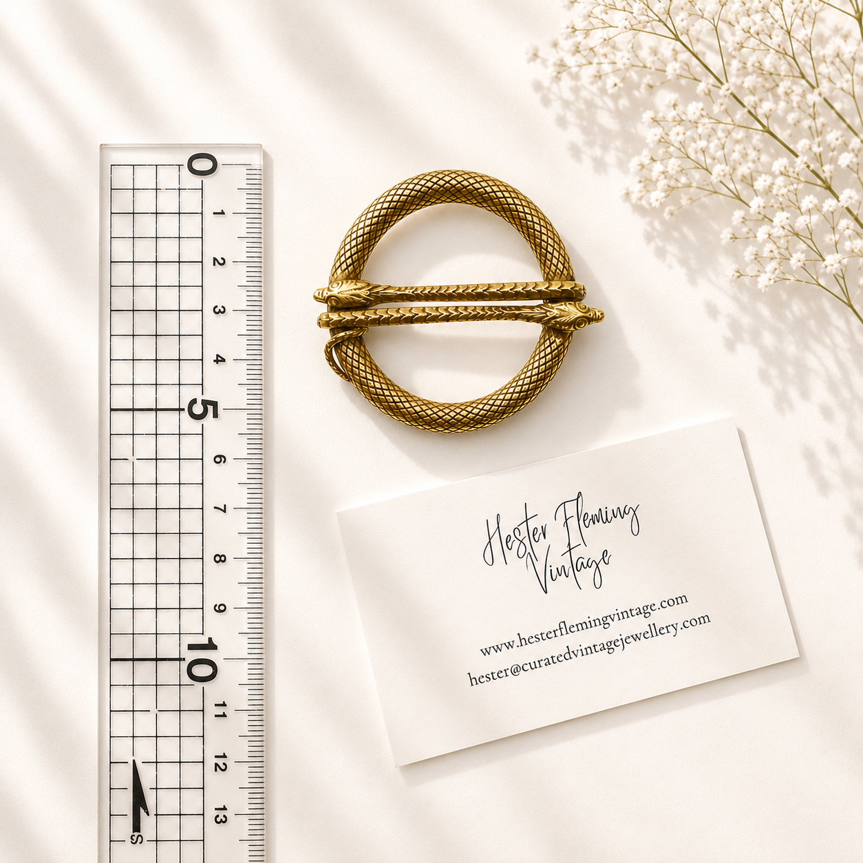 Brooch placed next to ruler for size. 6cm x 5.5cm