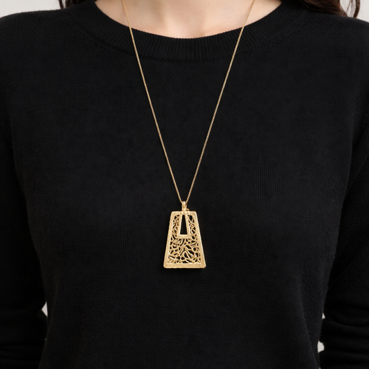 1970s Modernist Pendant, styled on a model wearing a fine black knit. 