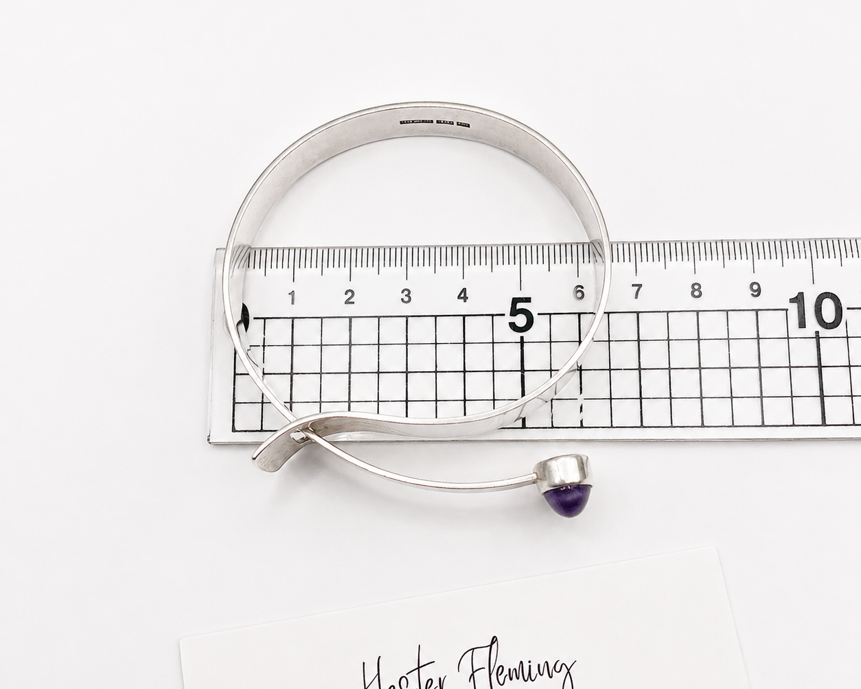 1970s Scandinavian Bangle, placed on a ruler for size. 