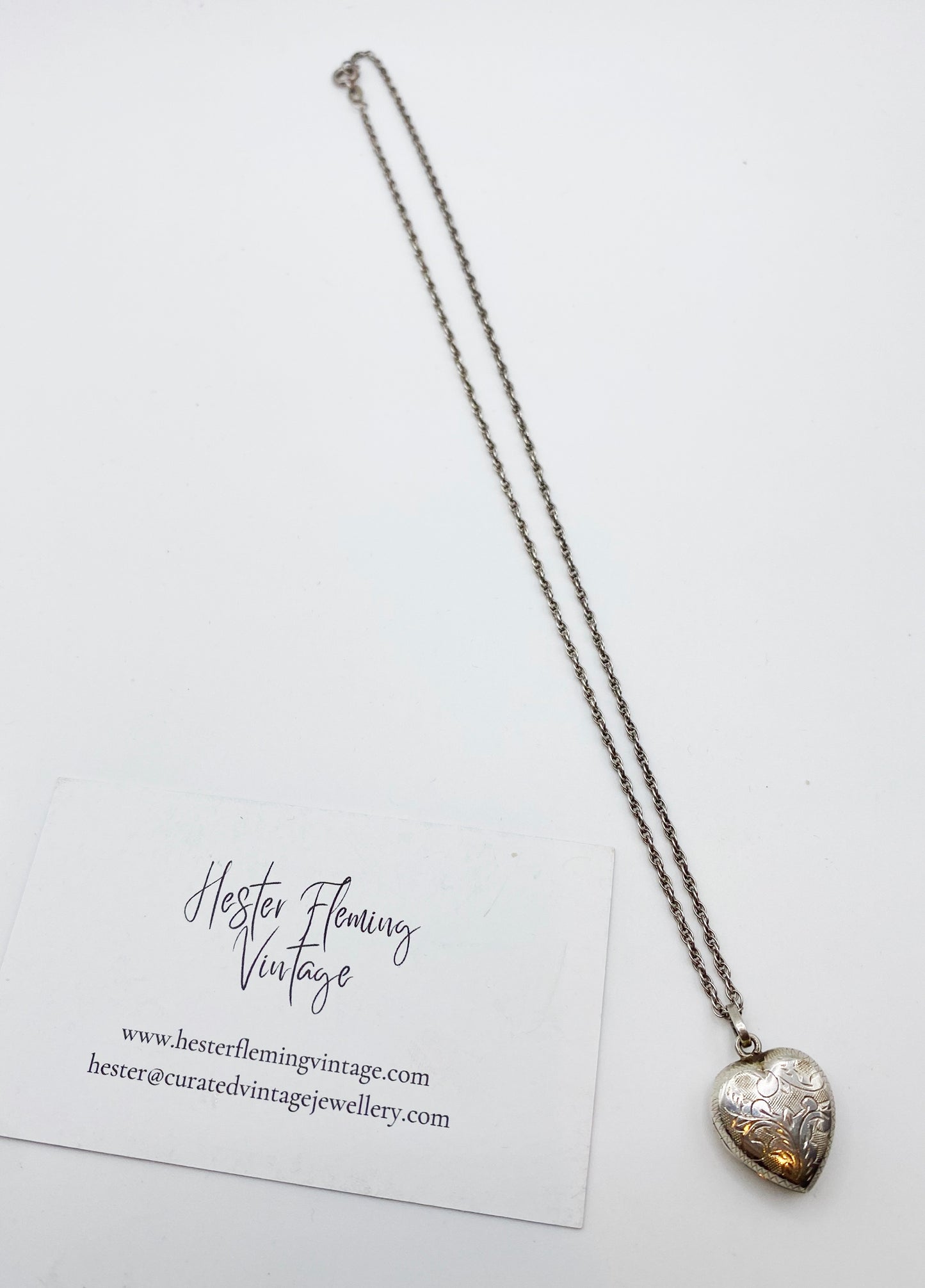 1980s 925 sterling silver heart locket with original chain laid flat
