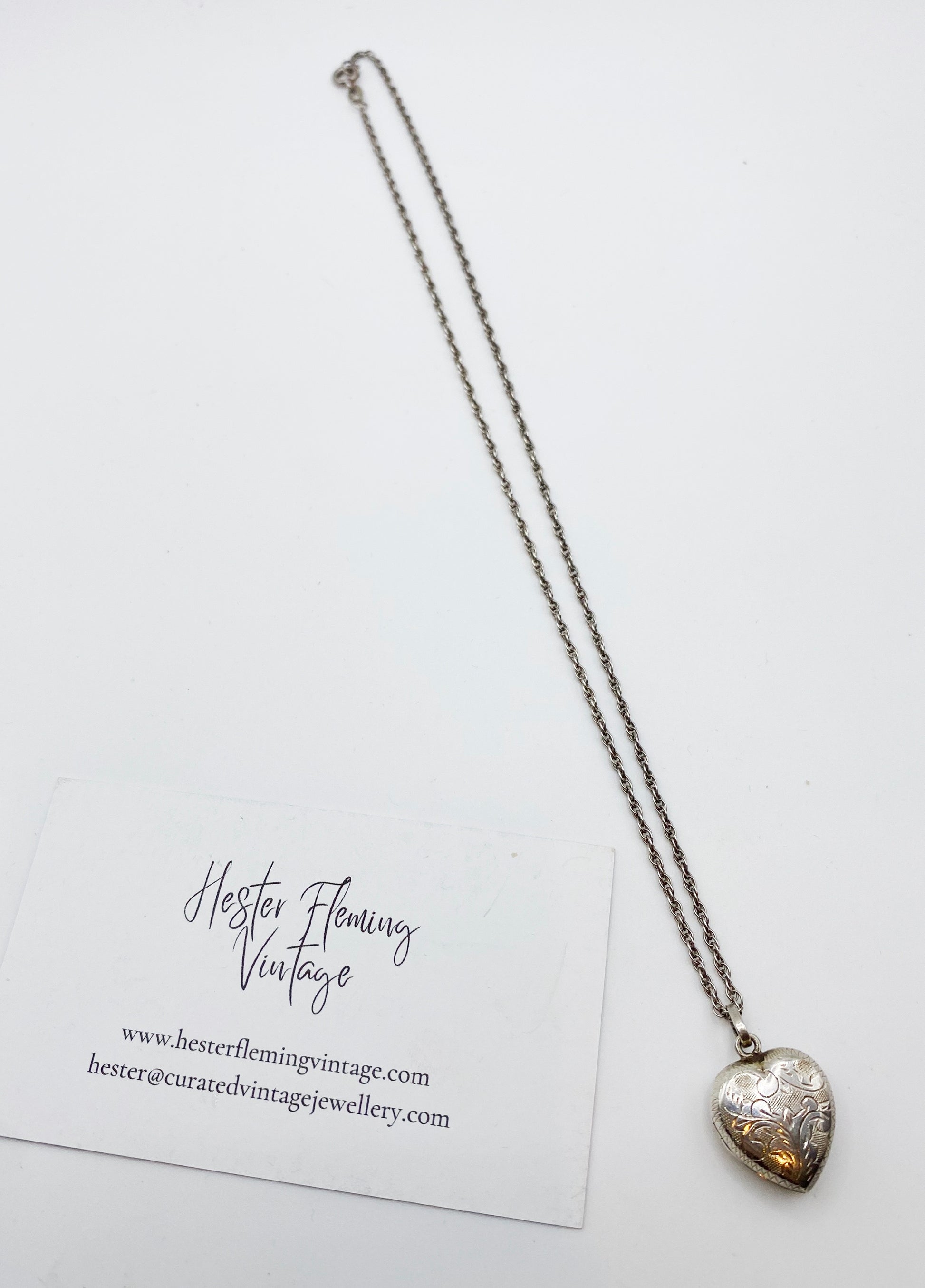 1980s 925 sterling silver heart locket with original chain laid flat