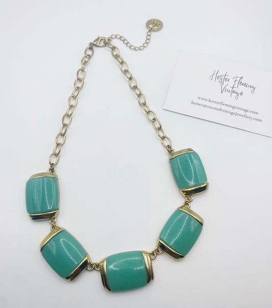 Front view of 1980s Crown Trifari gold-plated necklace with jade green glass panels