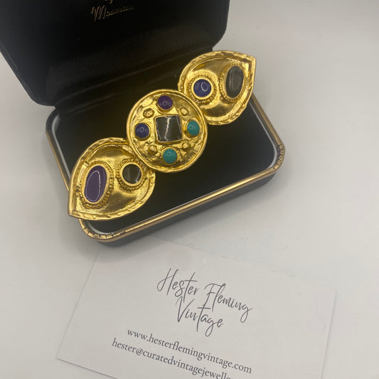 1980s Egyptian Revival brooch with 22kt gold plating and colorful enamel detailing, vintage costume jewellery statement pin displayed in box. 