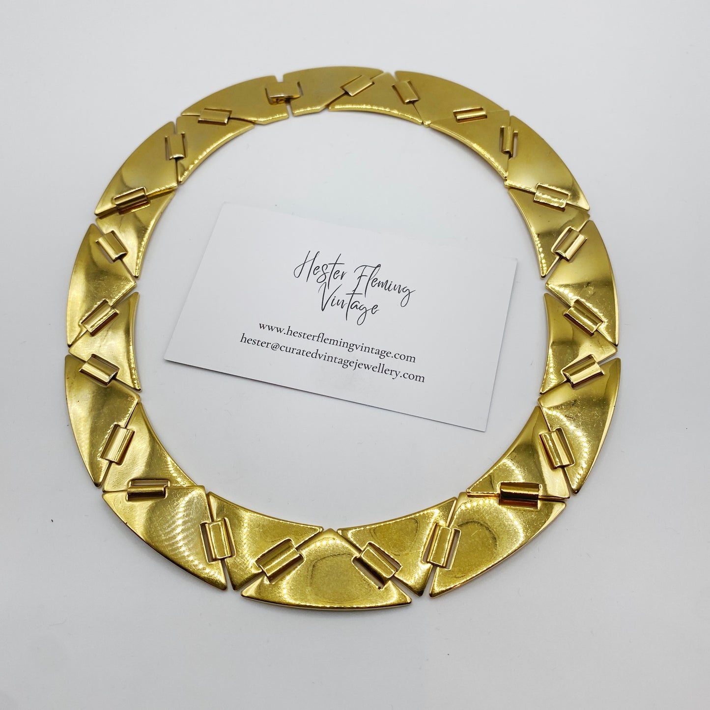 1980s gold-plated wide collar necklace, sits elegantly close to the neck.