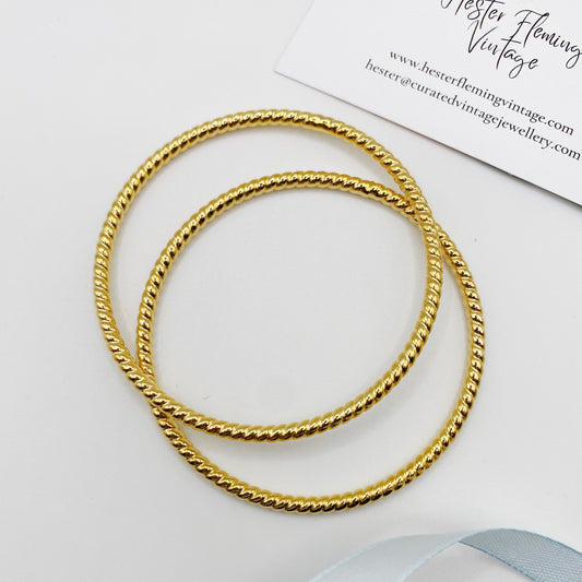 Stackable retro gold bangles from the 80s, shown on a white background