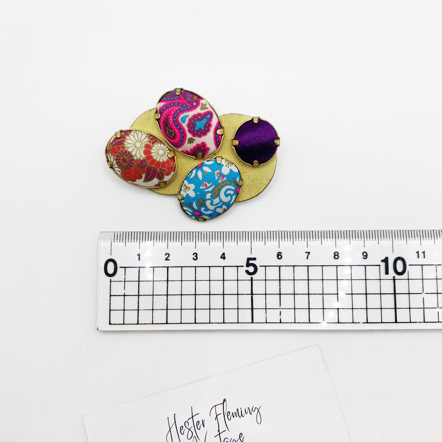 1980s 1990s Kenzo Brooch shown next to a ruler for scale.